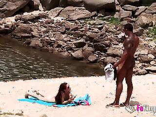 A wild encounter unfolds as a caught naked couple gets down and dirty on the beach. Their public display of passion leads to a steamy blowjob and intense sex.