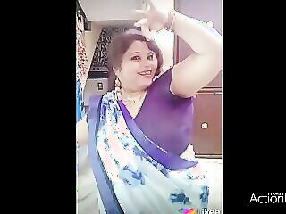 Sultry Indian babe with ample curves sheds her sari to reveal her juicy boobs, ready for a wild session of pleasure and pain.